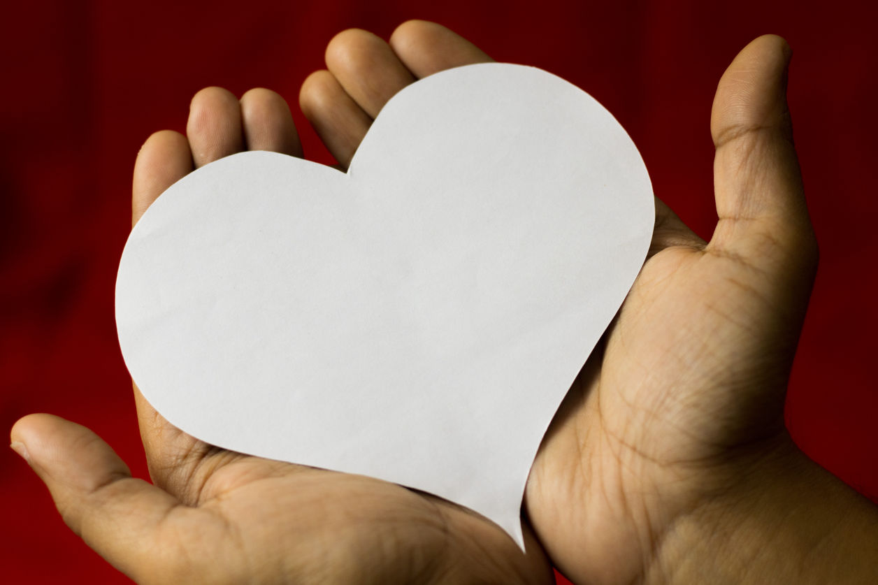 Image of a person holding a heart cutout